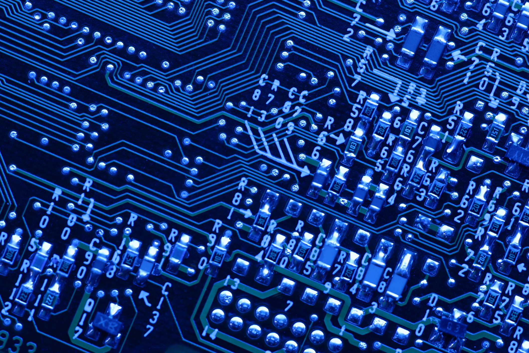 A closeup of a circuit board with a blue filter