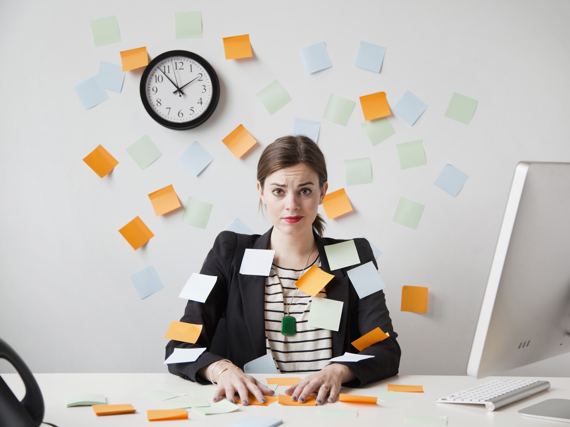 Woman Covered in Post-It Notes Looking Stressed